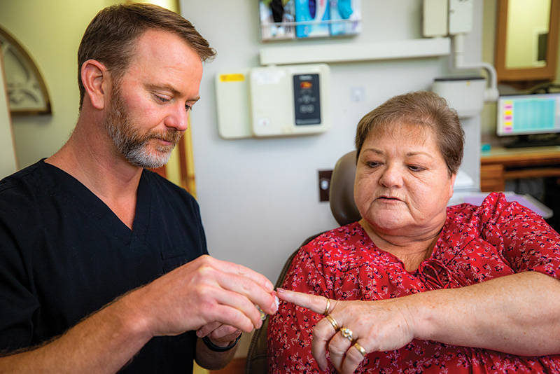 A woman from Overland Park, KS, discussing implant dentures