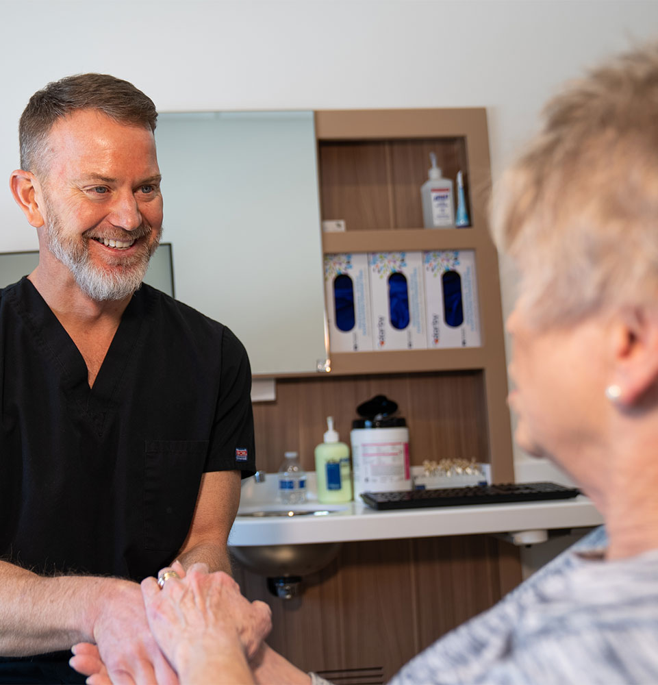 Dr. Michael Dostal shaking patients hand